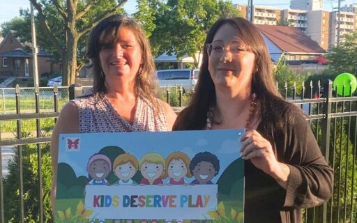 2 women holding kids deserve play poster
