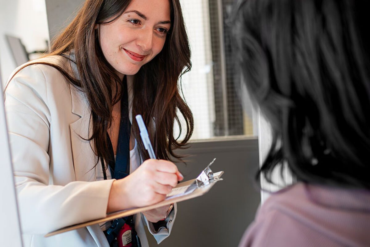 Women with intake form interviewing