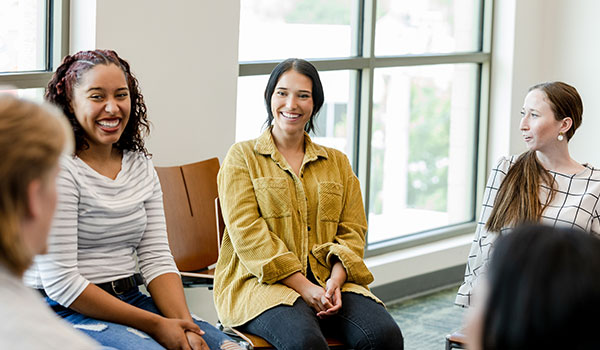 Women laughing and discussion in group setting