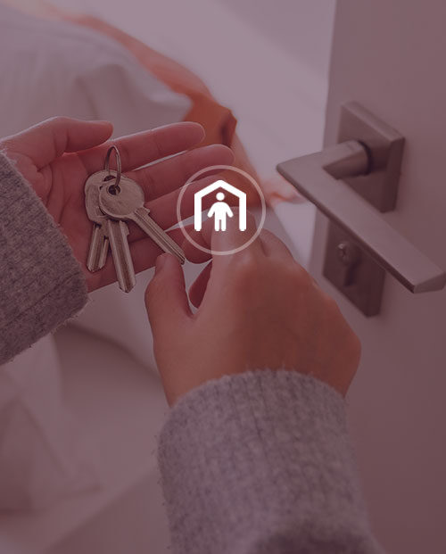 Woman holding keys by door