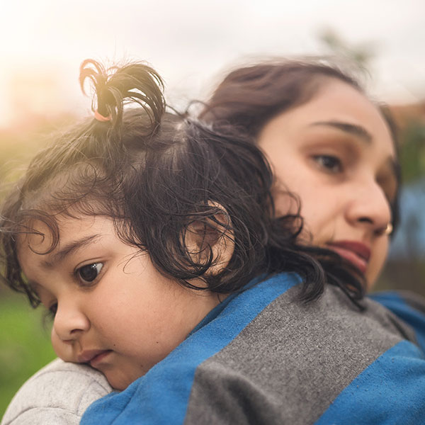 Mother hugging child dark hair