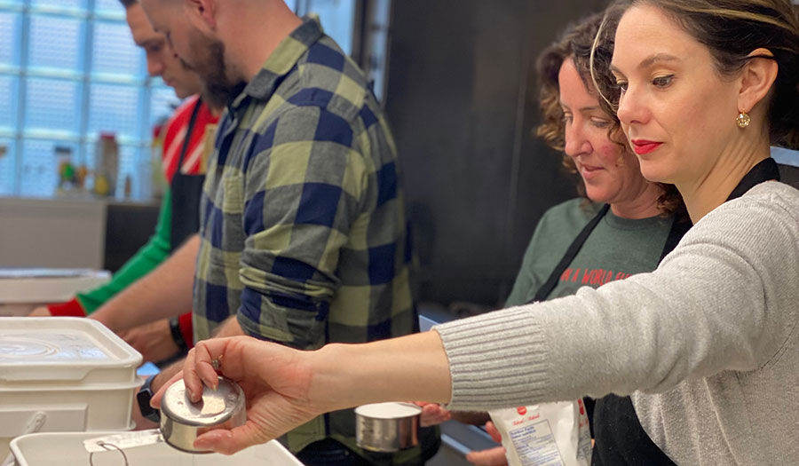 4 people in kitchen cooking