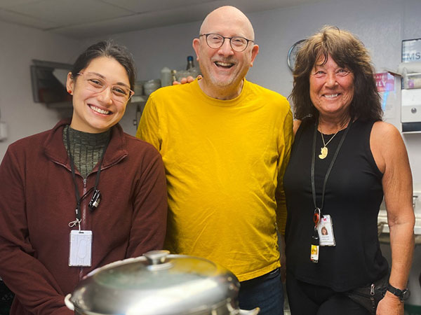 3 people smiling while volunteering