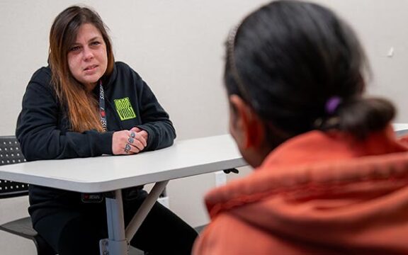 women's peer support woman assisting other woman