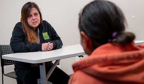 women's peer support woman assisting other woman
